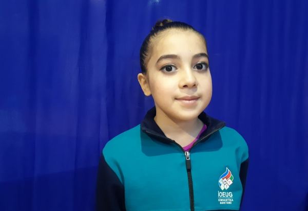 Participant of trampoline championship tries to improve her results at every training session